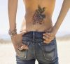 hummingbird pic tattoo on lower back of girl